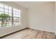Bedroom with a large window providing natural light and attractive wood flooring at 8442 Norman Forest Rd, Lancaster, SC 29720