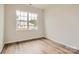 Well-lit bedroom featuring wood flooring, and a large window that provides ample light at 8442 Norman Forest Rd, Lancaster, SC 29720