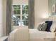 Bright bedroom featuring a large window, neutral colors, and a cozy bed, creating a relaxing atmosphere at 8442 Norman Forest Rd, Lancaster, SC 29720
