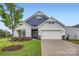Charming single-Gathering home featuring a two-car garage, well-manicured lawn, and beautiful landscaping at 8442 Norman Forest Rd, Lancaster, SC 29720