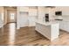 Spacious kitchen with white cabinetry, a large island, stainless steel appliances, and wood floors at 8442 Norman Forest Rd, Lancaster, SC 29720