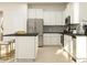 Modern kitchen featuring stainless steel appliances, white cabinets, and a gray backsplash at 8442 Norman Forest Rd, Lancaster, SC 29720