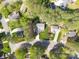 An aerial view highlights a lovely home on a tree-lined street at 8707 Copenhagen Ln, Charlotte, NC 28216