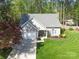 Aerial view of a well-kept home with lush green lawn, a driveway, and surrounded by beautiful trees at 8707 Copenhagen Ln, Charlotte, NC 28216