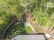 Aerial view showcases a manicured backyard with a fire pit and patio at 8707 Copenhagen Ln, Charlotte, NC 28216