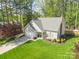 Overhead view of a charming house boasting a manicured lawn and a private driveway in a wooded neighborhood at 8707 Copenhagen Ln, Charlotte, NC 28216