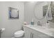 Neat half bath with a sink and a toilet in a room with gray walls and white molding at 8707 Copenhagen Ln, Charlotte, NC 28216