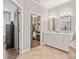 Bathroom featuring double vanity, tile flooring, a walk-in closet, and lots of natural light at 8707 Copenhagen Ln, Charlotte, NC 28216