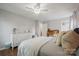 Charming bedroom features a ceiling fan, white dresser, and wood floors at 8707 Copenhagen Ln, Charlotte, NC 28216
