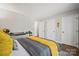 Bedroom with hardwood floors, gray and yellow color scheme provides a comfortable and relaxing space at 8707 Copenhagen Ln, Charlotte, NC 28216