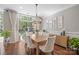 Bright dining room featuring hardwood floors, stylish decor, and a sliding door to the backyard at 8707 Copenhagen Ln, Charlotte, NC 28216