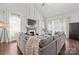 Spacious living room featuring a cozy sectional sofa, fireplace, hardwood floors and bright natural light at 8707 Copenhagen Ln, Charlotte, NC 28216
