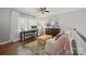 Upstairs living room with hardwood floors, bright windows and comfortable seating, ideal for relaxing at 8707 Copenhagen Ln, Charlotte, NC 28216