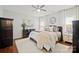 Main bedroom featuring plush bedding, neutral color palette, dark furniture, and plenty of natural light at 8707 Copenhagen Ln, Charlotte, NC 28216
