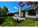 A backyard with a stone paver patio that leads to the back door is framed by green lawn at 8811 Steelechase Dr, Charlotte, NC 28273
