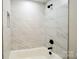 Bathtub featuring updated fixtures, modern tiling, and shower head at 8811 Steelechase Dr, Charlotte, NC 28273