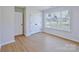 Bedroom featuring hardwood floors and a large window for plenty of natural light at 8811 Steelechase Dr, Charlotte, NC 28273