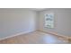 Cozy bedroom with a window and wood floors at 8811 Steelechase Dr, Charlotte, NC 28273