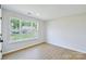 Comfortable bedroom with hardwood floors and a bright window overlooking the yard at 8811 Steelechase Dr, Charlotte, NC 28273