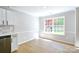 Bright dining area with wood floors, white walls, and a large window with lots of natural light at 8811 Steelechase Dr, Charlotte, NC 28273