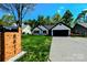 Inviting single-story home with well-manicured lawn, wooden shutters, a black roof and a striking mailbox at 8811 Steelechase Dr, Charlotte, NC 28273