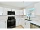 Modern kitchen featuring white cabinets, quartz countertops, tile backsplash, and stainless steel appliances at 8811 Steelechase Dr, Charlotte, NC 28273