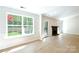 Bright living room with a fireplace, hardwood floors, and a large window with natural light at 8811 Steelechase Dr, Charlotte, NC 28273