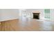 Bright living room featuring wood floors, a fireplace, and large windows that bring in natural light at 8811 Steelechase Dr, Charlotte, NC 28273