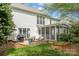 Backyard featuring a fire pit, outdoor seating, and large screened-in porch at 8929 Lizzie Ln, Huntersville, NC 28078