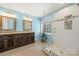 Bathroom featuring a dual sink vanity with granite countertops, a large shower, and modern fixtures at 8929 Lizzie Ln, Huntersville, NC 28078