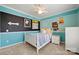 Cozy bedroom featuring blue walls, a ceiling fan and natural light at 8929 Lizzie Ln, Huntersville, NC 28078