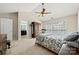 Bedroom featuring an ensuite bathroom, a bed with patterned bedding, and a large window with natural light at 8929 Lizzie Ln, Huntersville, NC 28078