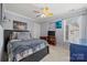 Bright bedroom features a ceiling fan, natural light, and colorful decor at 8929 Lizzie Ln, Huntersville, NC 28078
