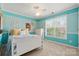 Bright bedroom with blue walls and decor, ceiling fan, and plenty of natural light at 8929 Lizzie Ln, Huntersville, NC 28078