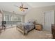 Bright bedroom with a ceiling fan, natural light, and a comfortable bed; perfect for relaxation at 8929 Lizzie Ln, Huntersville, NC 28078