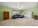 Spacious bonus room with comfortable couch, neutral carpeting, and ceiling fan at 8929 Lizzie Ln, Huntersville, NC 28078