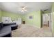 Bonus room featuring neutral carpeting, ceiling fan, and large windows at 8929 Lizzie Ln, Huntersville, NC 28078