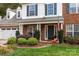 Inviting front porch with decorative plants enhancing the curb appeal of this charming brick home at 8929 Lizzie Ln, Huntersville, NC 28078
