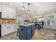 Spacious kitchen featuring an island, white cabinets, and adjacent dining area at 8929 Lizzie Ln, Huntersville, NC 28078