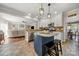 Open kitchen with white cabinets, stainless appliances, and a center island with seating at 8929 Lizzie Ln, Huntersville, NC 28078