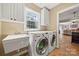 Functional laundry room equipped with washer, dryer, and utility sink at 8929 Lizzie Ln, Huntersville, NC 28078