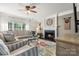 Comfortable living room with a fireplace, ceiling fan, and plenty of natural light at 8929 Lizzie Ln, Huntersville, NC 28078