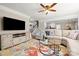 Open living room with a large TV, comfortable seating, and an open view to the kitchen at 8929 Lizzie Ln, Huntersville, NC 28078