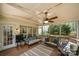 Screened-in porch features wooded views, two couches, and ceiling fan at 8929 Lizzie Ln, Huntersville, NC 28078