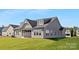 A backyard featuring a well-maintained lawn and exterior view of the screened-in porch at 908 Cypress Point Ln # 218, Monroe, NC 28112