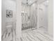 A bathroom featuring modern shower with vertical tiling, built-in bench, and glass surround at 908 Cypress Point Ln # 218, Monroe, NC 28112