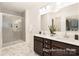 Bathroom featuring double vanity sinks, a large mirror, a walk-in glass shower, and modern fixtures at 908 Cypress Point Ln # 218, Monroe, NC 28112