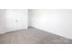 A spacious bedroom featuring neutral carpeting, a double door closet, and ample natural light at 908 Cypress Point Ln # 218, Monroe, NC 28112