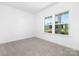 A bright bedroom with large windows overlooking a serene, green neighborhood at 908 Cypress Point Ln # 218, Monroe, NC 28112