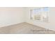Minimalist bedroom with neutral carpet, large windows for natural light, and a clean, uncluttered space at 908 Cypress Point Ln # 218, Monroe, NC 28112